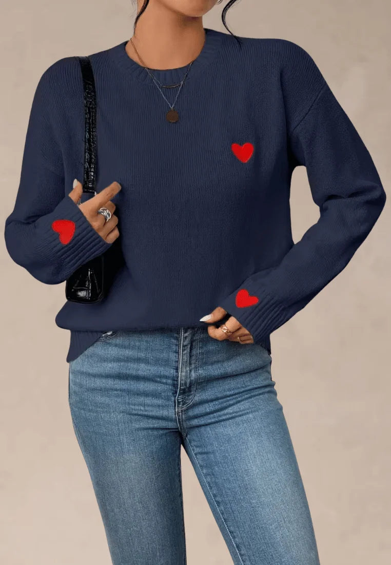 Granatowy sweter damski z czerwonymi serduszkami na piersi i rękawach