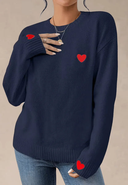 Granatowy sweter damski z czerwonymi serduszkami na piersi i rękawach