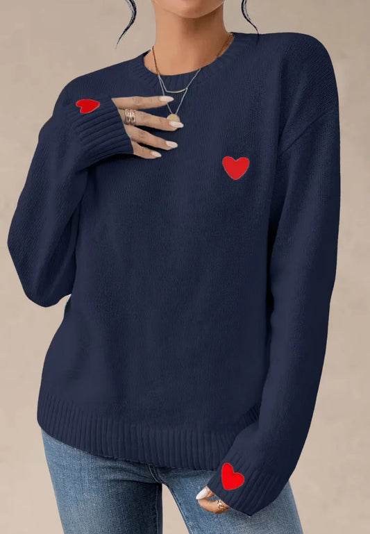 Granatowy sweter damski z czerwonymi serduszkami na piersi i rękawach