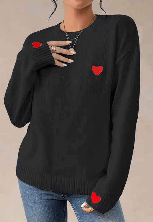 Czarny sweter damski z czerwonymi serduszkami na piersi i rękawach